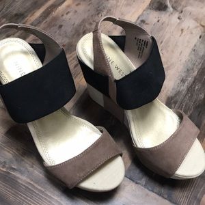 Taupe and black wedge sandals.